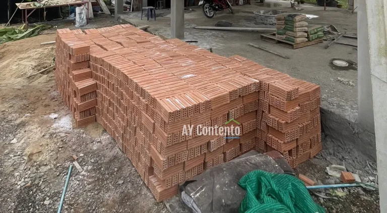 A stack of large, high-quality, 8-hole clay bricks is arranged and ready for house wall construction at a construction site in Khlong Luang District.